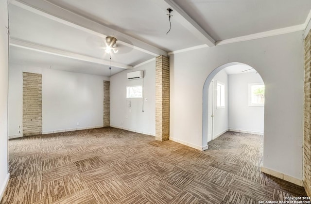 unfurnished living room with a wall unit AC, ceiling fan, beam ceiling, and carpet floors