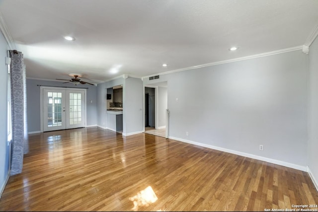 unfurnished living room with hardwood / wood-style flooring, ceiling fan, crown molding, and french doors