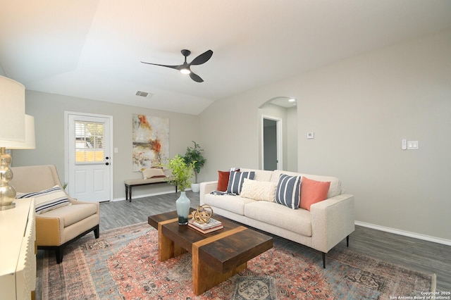 living room with ceiling fan, dark wood-type flooring, and vaulted ceiling