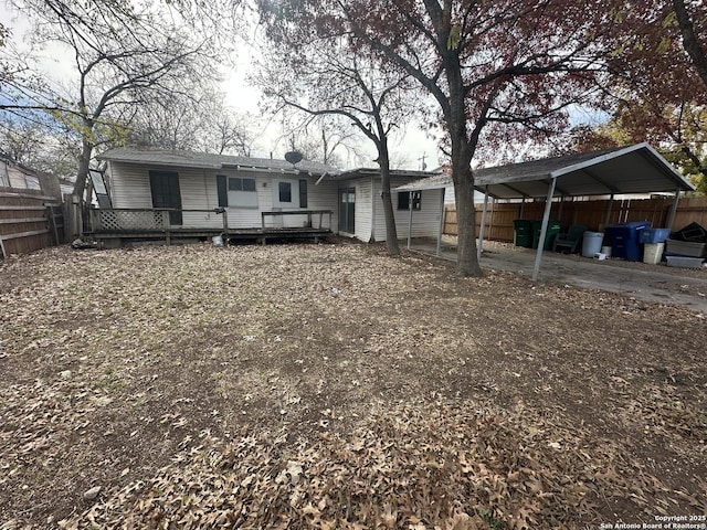 view of front of property with a wooden deck and a carport