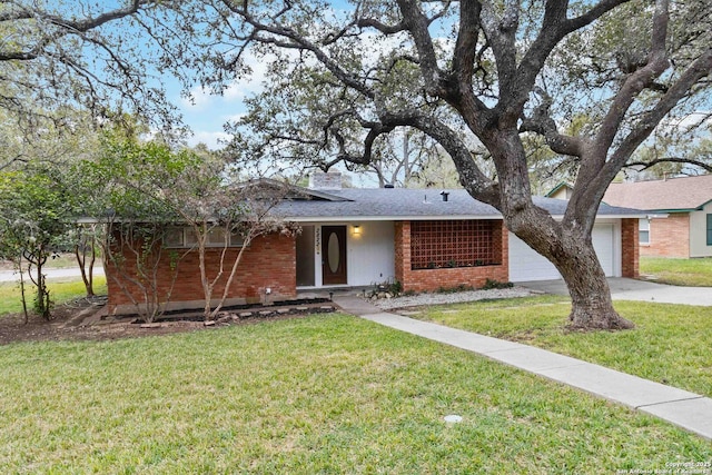 single story home featuring a garage and a front yard