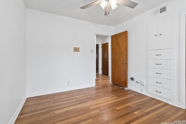 unfurnished bedroom with ceiling fan and wood-type flooring