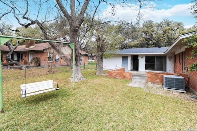 view of yard with central air condition unit and a patio