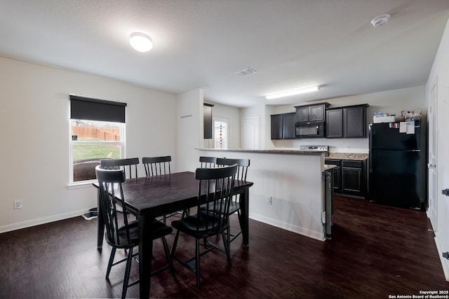 dining space with dark wood-type flooring