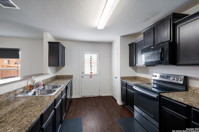 kitchen with a wealth of natural light, sink, dark wood-type flooring, and stainless steel range with electric cooktop