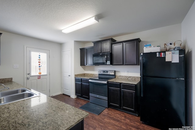 kitchen with a textured ceiling, dark wood-type flooring, sink, and black appliances