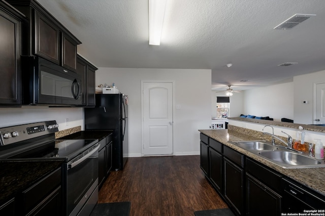 kitchen with ceiling fan, black appliances, sink, a textured ceiling, and dark hardwood / wood-style flooring