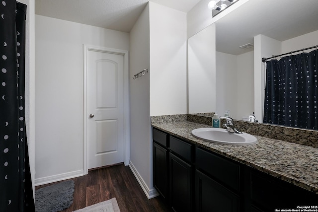 bathroom with hardwood / wood-style floors and vanity