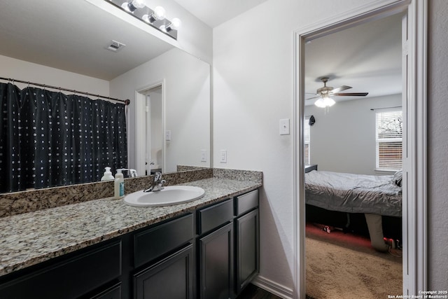 bathroom with ceiling fan, a shower with shower curtain, and vanity