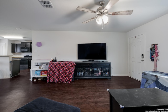 living room with ceiling fan and dark hardwood / wood-style floors