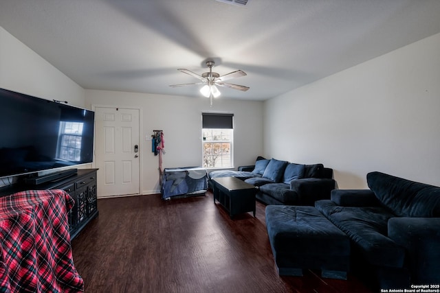 living room with ceiling fan and dark hardwood / wood-style flooring