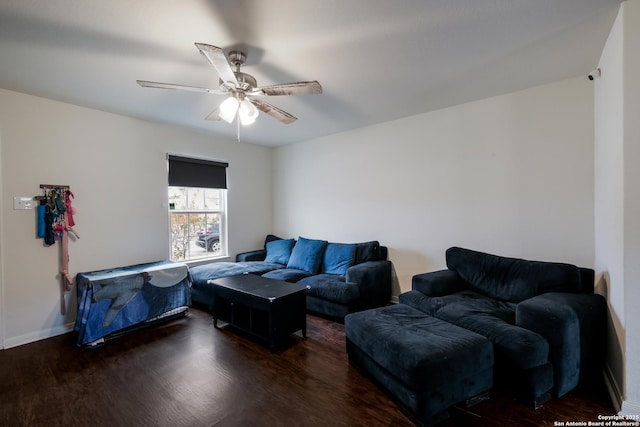 living room with ceiling fan and dark hardwood / wood-style flooring