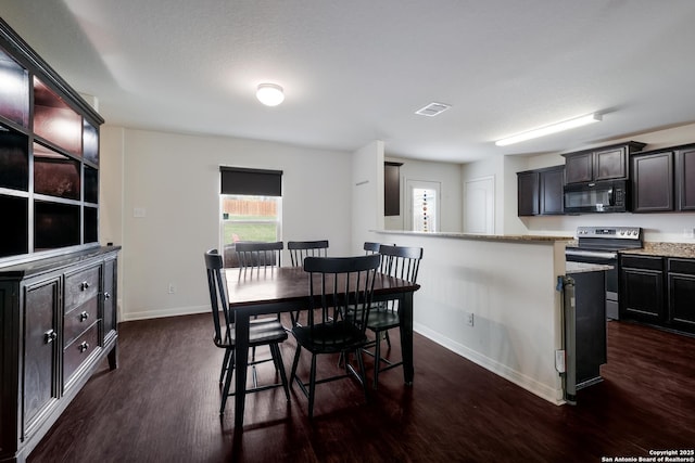 dining room featuring dark hardwood / wood-style flooring