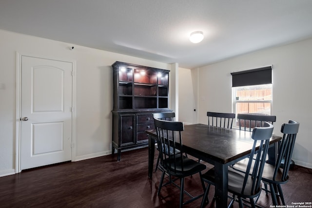 dining room with dark hardwood / wood-style flooring