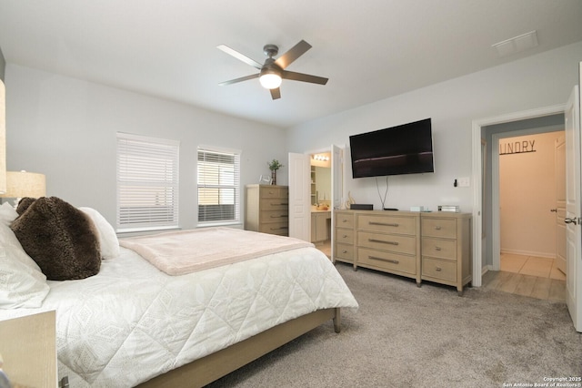 carpeted bedroom featuring ceiling fan and connected bathroom