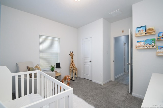 carpeted bedroom with a nursery area