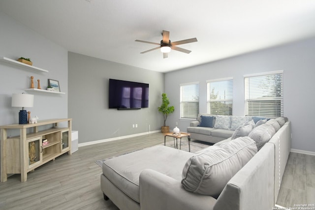 living room featuring ceiling fan and light hardwood / wood-style floors