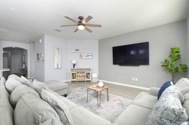 living room featuring light wood-type flooring and ceiling fan