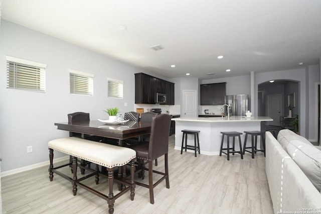 dining area featuring light hardwood / wood-style floors and sink