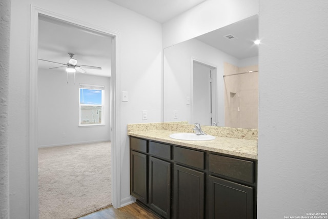 bathroom with ceiling fan, vanity, and hardwood / wood-style floors