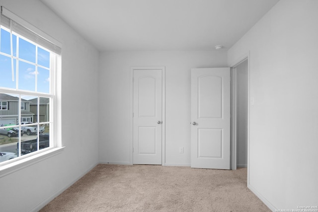 unfurnished bedroom featuring light colored carpet