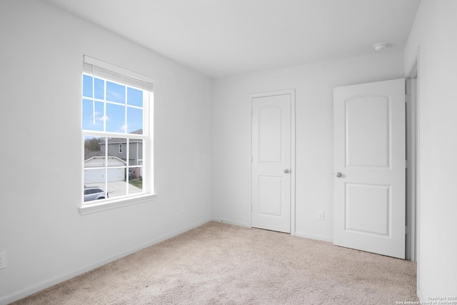 unfurnished bedroom with light colored carpet