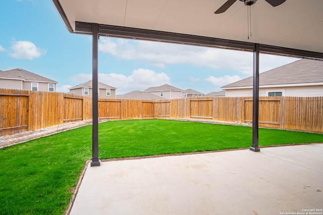 view of yard with a patio area and ceiling fan