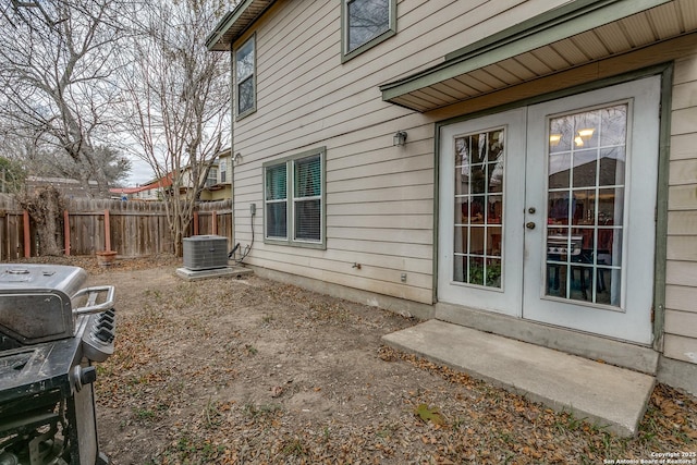 view of side of property featuring central AC unit and french doors