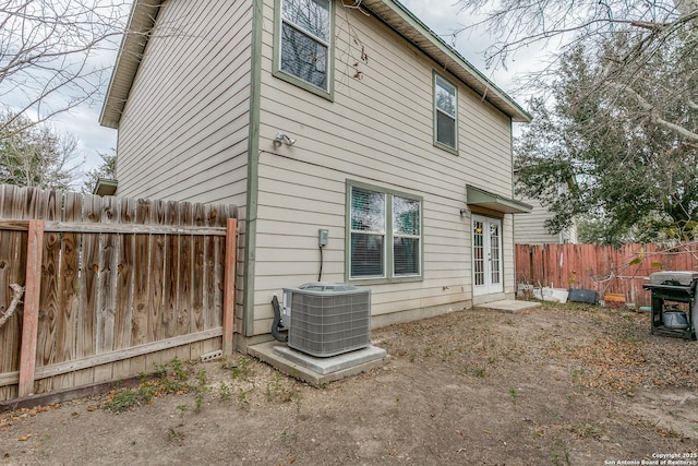 rear view of property featuring central AC unit