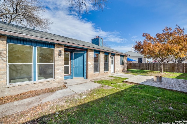 back of house featuring a patio and a lawn