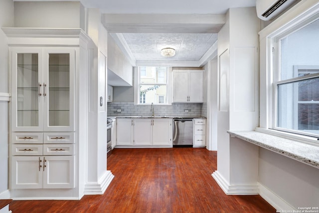 kitchen featuring stainless steel appliances, decorative backsplash, light stone countertops, white cabinets, and sink