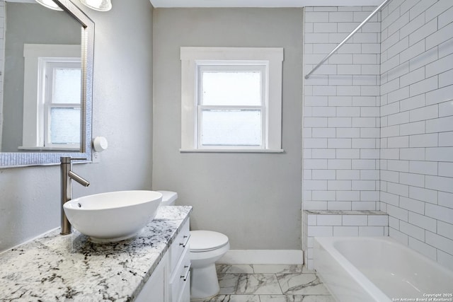 full bathroom with toilet, vanity, and tiled shower / bath combo