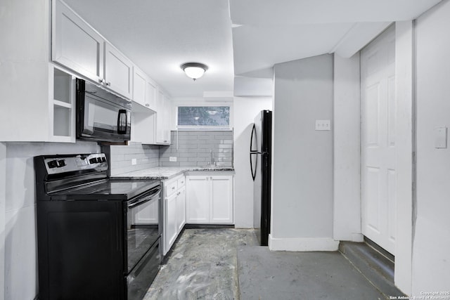 kitchen featuring tasteful backsplash, black appliances, sink, light stone countertops, and white cabinets