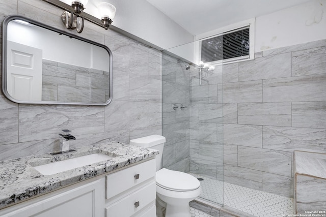 bathroom with toilet, an enclosed shower, and vanity