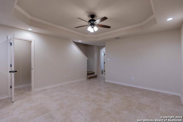 unfurnished room featuring ceiling fan, crown molding, and a raised ceiling