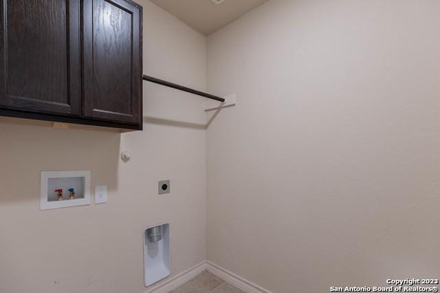 laundry room with light tile patterned flooring, cabinets, hookup for a washing machine, and hookup for an electric dryer