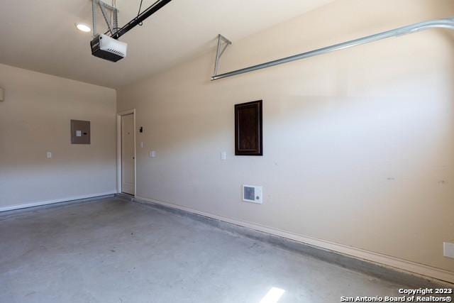 garage featuring a garage door opener and electric panel