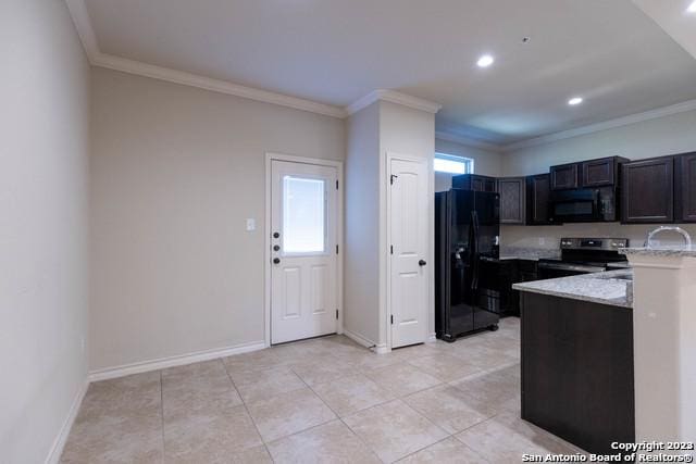 kitchen with light tile patterned flooring, ornamental molding, light stone counters, and black appliances