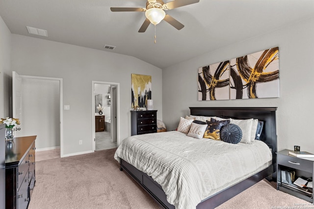 bedroom with ceiling fan, ensuite bathroom, lofted ceiling, and carpet flooring