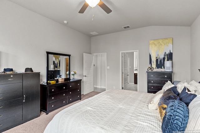 bedroom featuring ceiling fan, vaulted ceiling, carpet, and ensuite bathroom