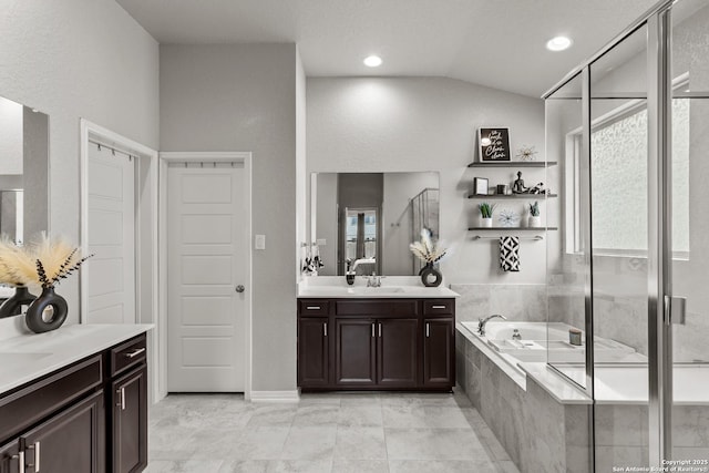 bathroom with separate shower and tub, vanity, vaulted ceiling, and tile patterned floors