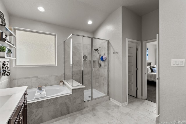 bathroom featuring a textured ceiling, tile patterned floors, vanity, and separate shower and tub