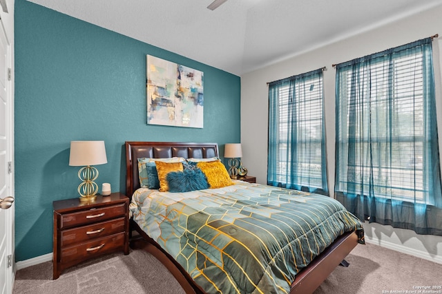 carpeted bedroom featuring ceiling fan and lofted ceiling