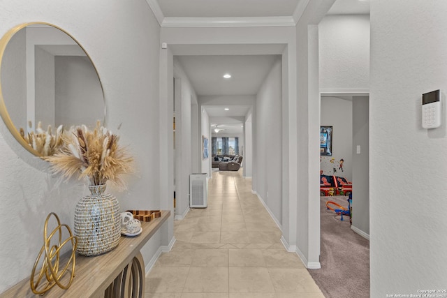 corridor featuring light colored carpet and crown molding