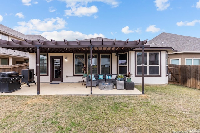 rear view of property featuring an outdoor living space with a fire pit, a yard, and a patio