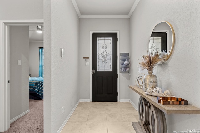 carpeted entryway with ornamental molding