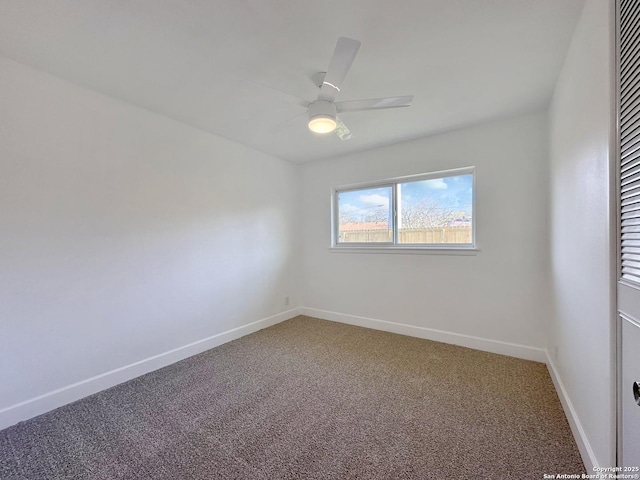 unfurnished room with ceiling fan and carpet