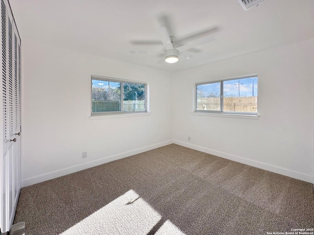 unfurnished bedroom with ceiling fan, a closet, and carpet flooring