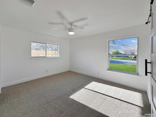 empty room with ceiling fan and carpet floors