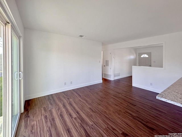 unfurnished room with dark hardwood / wood-style flooring